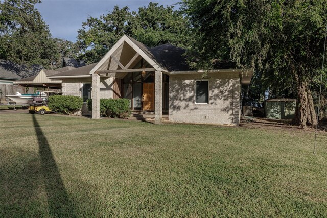 1457 Riverside Dr, West Tawakoni, TX 75474 - view of front of property featuring brick siding and a front yard