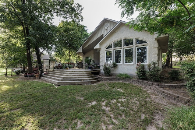 1457 Riverside Dr, West Tawakoni, TX 75474 - exterior space featuring brick siding, a deck, and a lawn