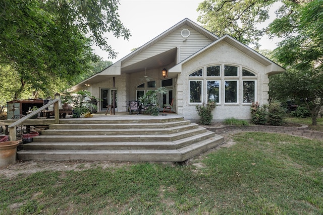 back of house featuring a lawn