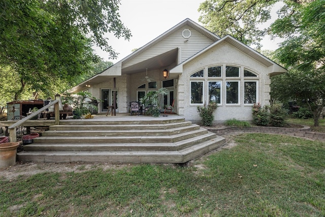 1457 Riverside Dr, West Tawakoni, TX 75474 - back of house featuring a lawn and brick siding