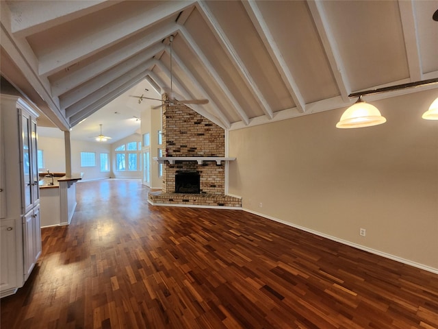 1457 Riverside Dr, West Tawakoni, TX 75474 - unfurnished living room with a ceiling fan, dark wood-style floors, beam ceiling, and baseboards