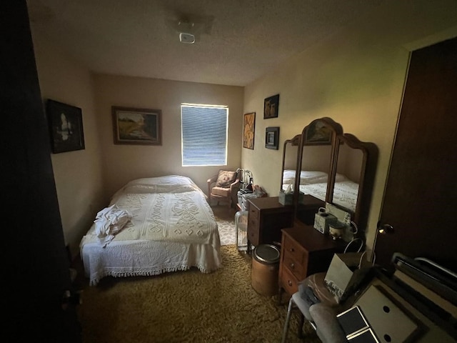 bedroom featuring carpet flooring and a textured ceiling