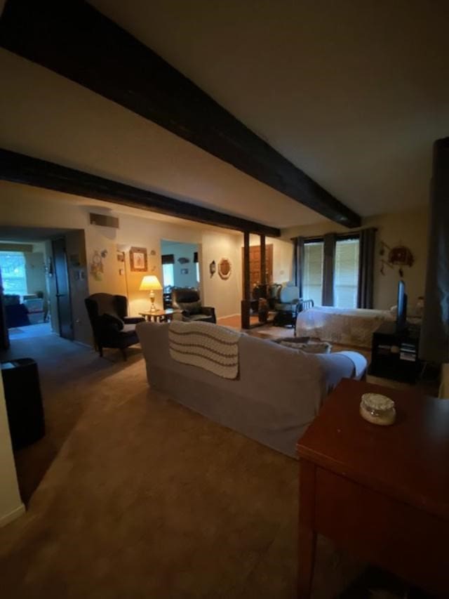 living room with beam ceiling and a wealth of natural light