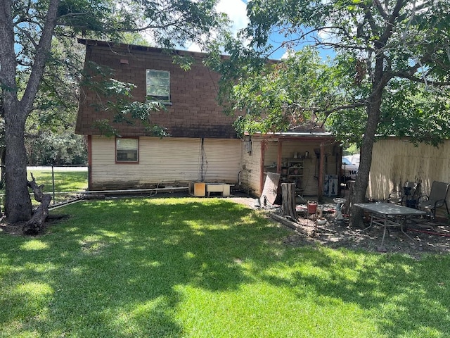 rear view of house featuring a lawn