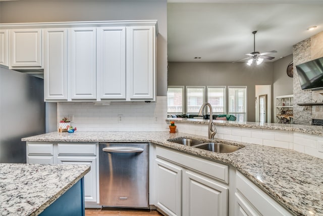 kitchen with sink, white cabinetry, backsplash, and stainless steel appliances