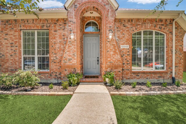 entrance to property with a lawn