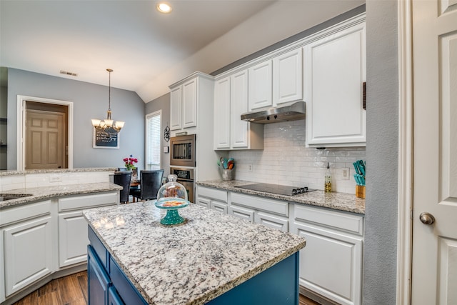 kitchen featuring stainless steel appliances, pendant lighting, decorative backsplash, a center island, and dark wood-type flooring