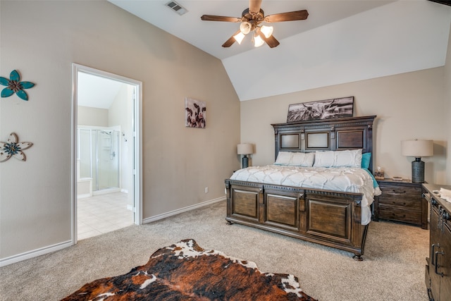 bedroom featuring ensuite bath, light colored carpet, vaulted ceiling, and ceiling fan