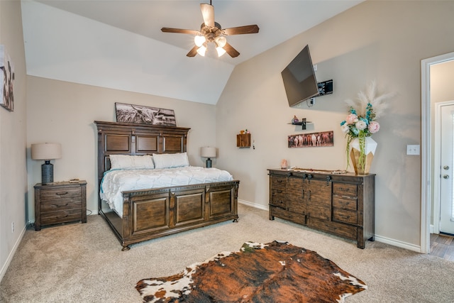 bedroom with light colored carpet, vaulted ceiling, and ceiling fan