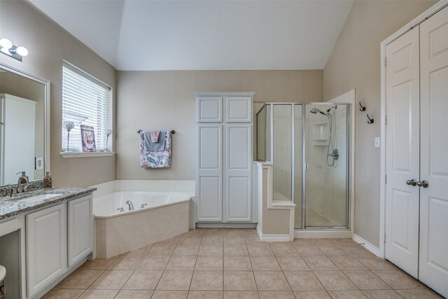 bathroom with tile patterned flooring, shower with separate bathtub, and vanity