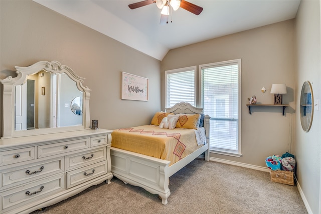 carpeted bedroom with ceiling fan and vaulted ceiling