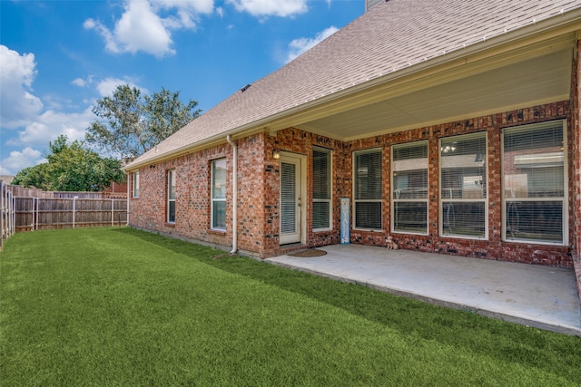 exterior space featuring a patio area and a lawn