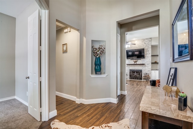 corridor with built in shelves and dark hardwood / wood-style flooring