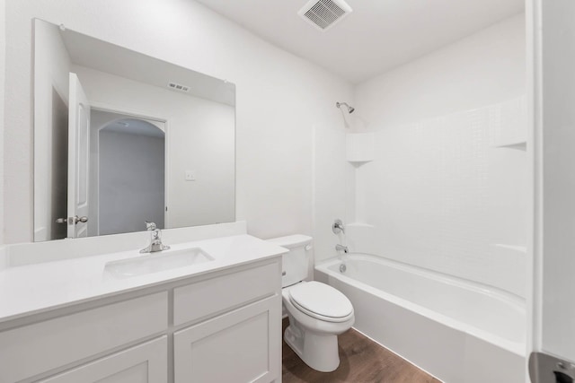 full bathroom featuring bathtub / shower combination, vanity, hardwood / wood-style flooring, and toilet