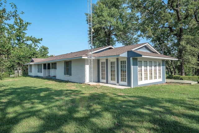 back of property with a lawn