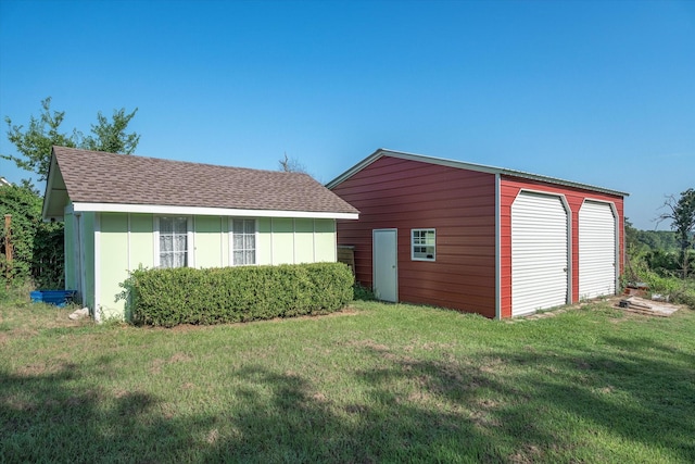 view of outbuilding with a garage and a yard