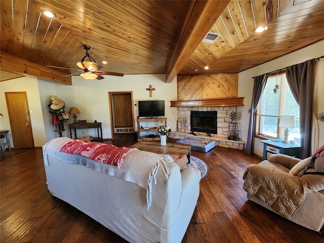 living room featuring beam ceiling, dark hardwood / wood-style flooring, ceiling fan, wooden ceiling, and a stone fireplace