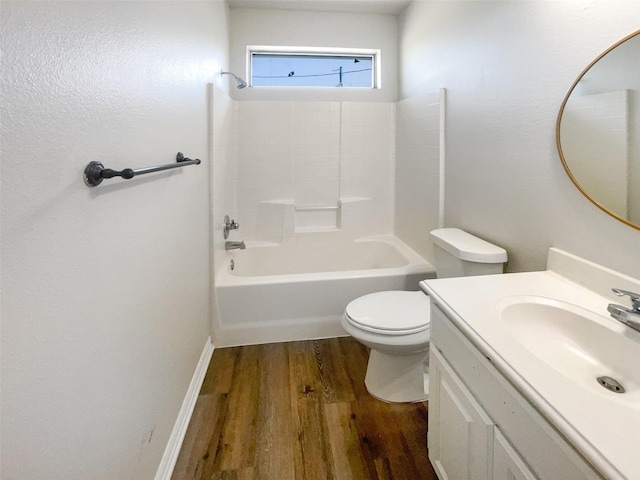 full bathroom featuring vanity, hardwood / wood-style flooring, tub / shower combination, and toilet