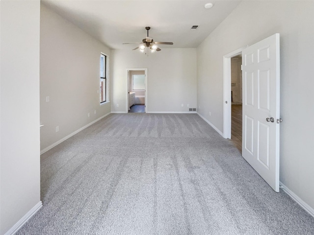 carpeted spare room with ceiling fan