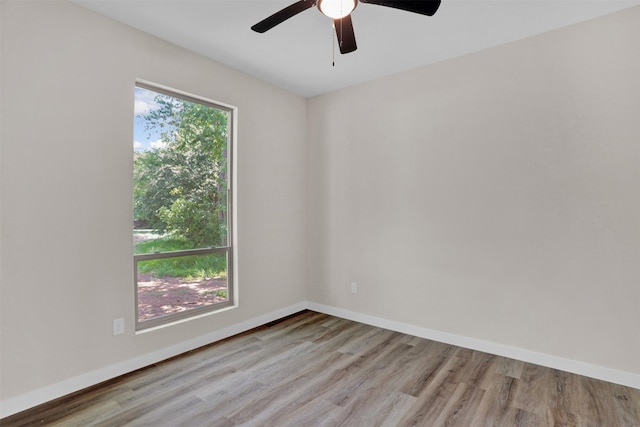 spare room with ceiling fan and light wood-type flooring