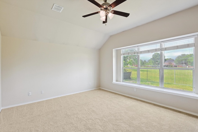 empty room with carpet, ceiling fan, and vaulted ceiling