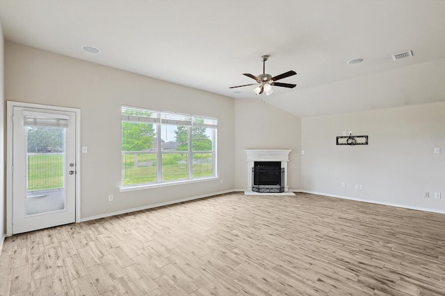 10517 Wentworth Dr, Rowlett, TX 75089 - unfurnished living room with light wood-style floors, a fireplace with raised hearth, healthy amount of natural light, a ceiling fan, and vaulted ceiling