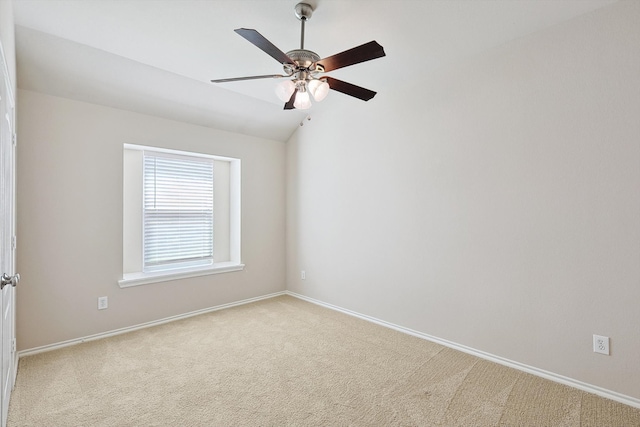 unfurnished room with ceiling fan, light colored carpet, and vaulted ceiling