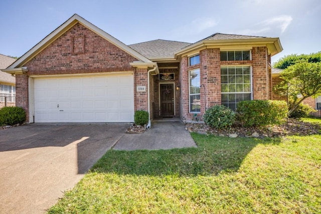 1514 Murphy Dr, Rockwall, TX 75087 - single story home featuring driveway, brick siding, a garage, and a front lawn