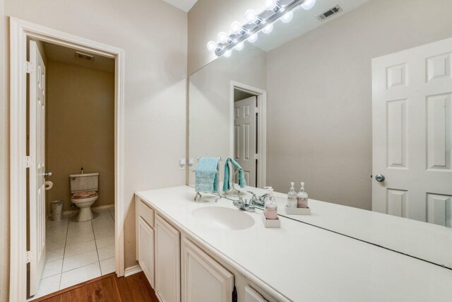 1514 Murphy Dr, Rockwall, TX 75087 - bathroom featuring visible vents, toilet, tile patterned floors, and vanity