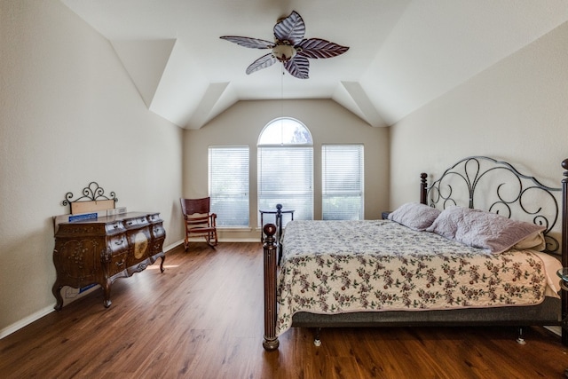 bedroom featuring dark hardwood / wood-style floors, ceiling fan, and vaulted ceiling