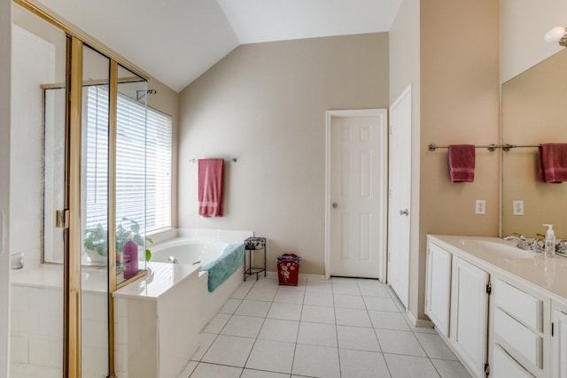 bathroom with vanity, independent shower and bath, lofted ceiling, and tile patterned floors