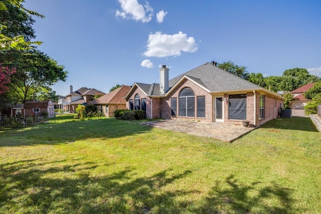 1514 Murphy Dr, Rockwall, TX 75087 - back of property featuring a yard, brick siding, fence, and a chimney