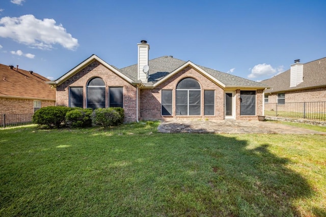 1514 Murphy Dr, Rockwall, TX 75087 - back of house with a chimney, fence, brick siding, and a yard