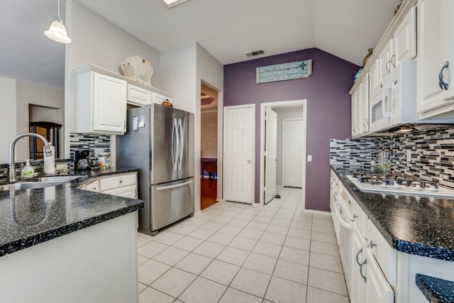 kitchen with sink, decorative light fixtures, white cabinetry, lofted ceiling, and white gas cooktop