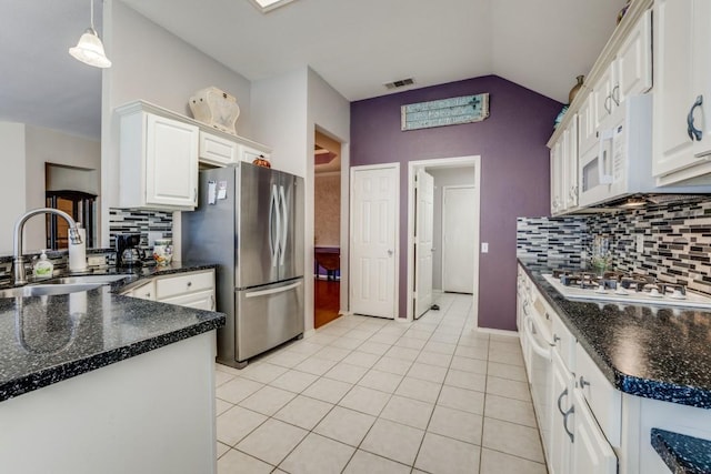 1514 Murphy Dr, Rockwall, TX 75087 - kitchen with a sink, lofted ceiling, light tile patterned floors, white appliances, and visible vents