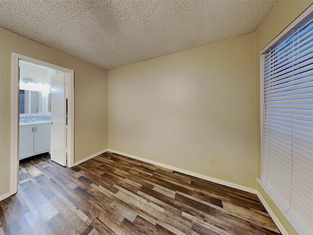 interior space featuring dark hardwood / wood-style flooring and a textured ceiling