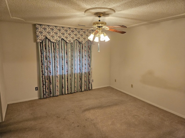 carpeted spare room featuring ceiling fan and a textured ceiling