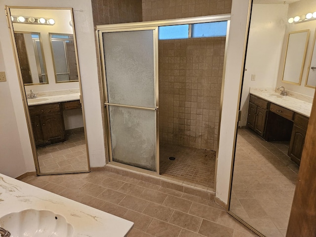 bathroom featuring vanity and a shower with door