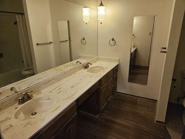 bathroom featuring hardwood / wood-style floors, vanity, and toilet