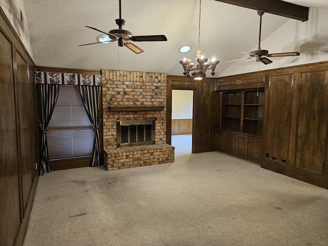 unfurnished living room with light carpet, a brick fireplace, lofted ceiling with beams, a textured ceiling, and wooden walls