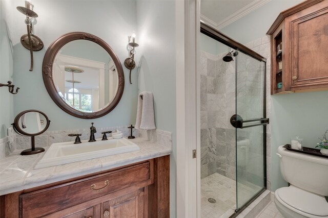 bathroom with ornamental molding, vanity, toilet, and an enclosed shower