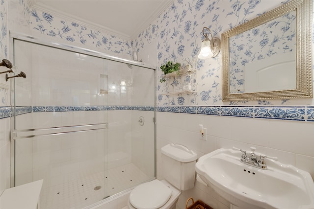 bathroom featuring tile walls, sink, walk in shower, ornamental molding, and toilet