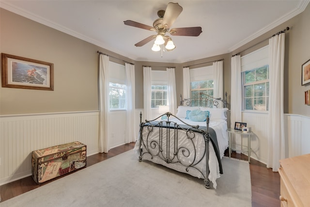 bedroom featuring ornamental molding, dark hardwood / wood-style flooring, and ceiling fan