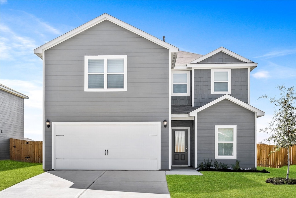 view of front of house featuring a front lawn and a garage