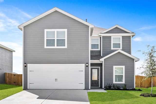 view of front of house featuring a front lawn and a garage