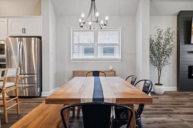 kitchen with appliances with stainless steel finishes, pendant lighting, white cabinetry, and sink