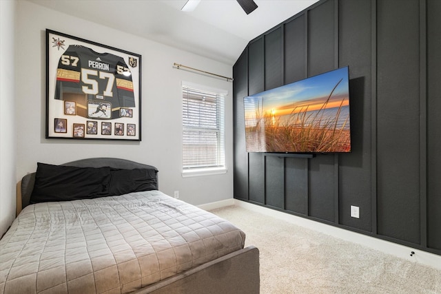 bedroom with vaulted ceiling, ceiling fan, and light colored carpet