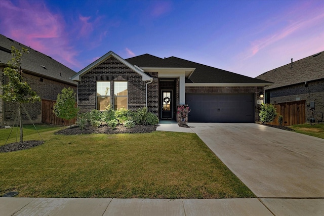 view of front of house with a garage and a lawn