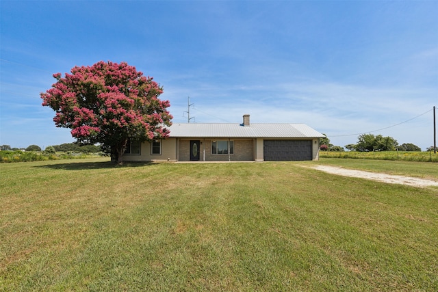 ranch-style home featuring a garage and a front lawn