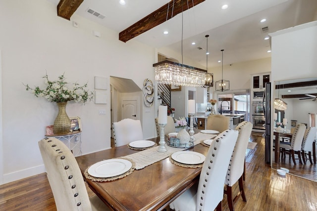 dining room featuring ceiling fan, sink, beamed ceiling, and dark hardwood / wood-style floors